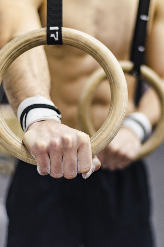 Man training with gymnastic rings in gym