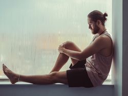Man in mindfulness on window sill