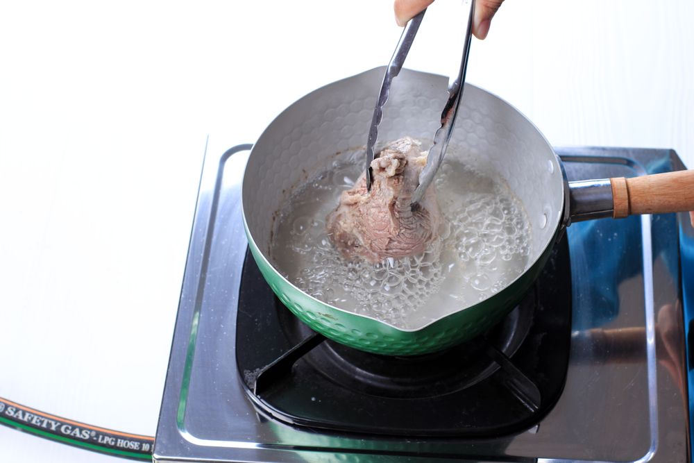 Woman Hand Boiled Beef on The Pan