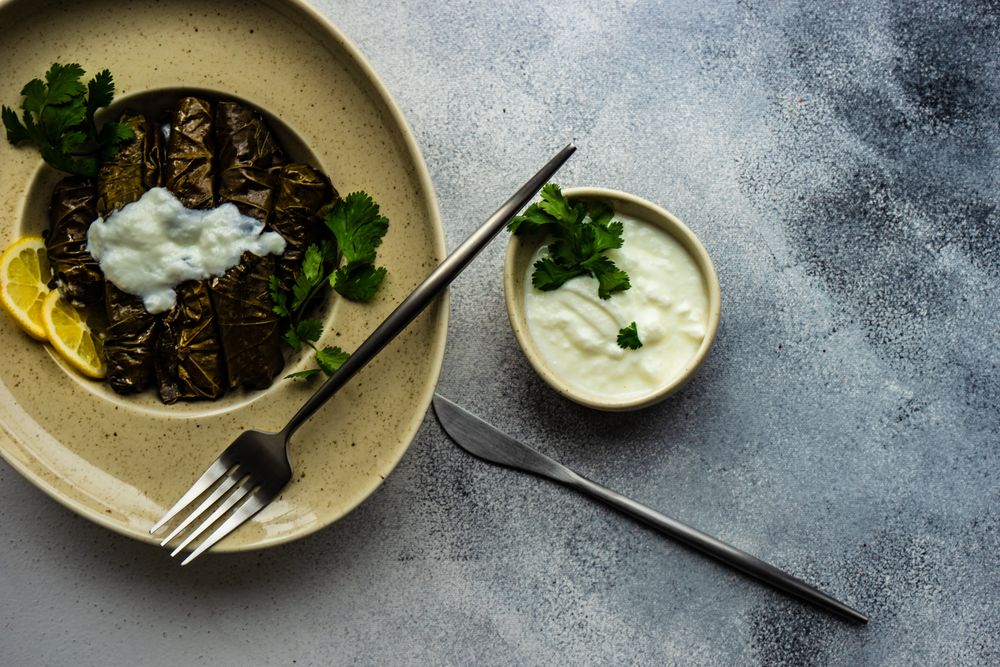 Top view of plate of stuffed grape leaves