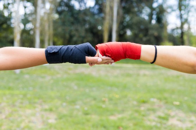 Boxer women bumping wrapped fists boxing outdoors