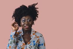 Portrait of Black woman with her hand up in studio shoot