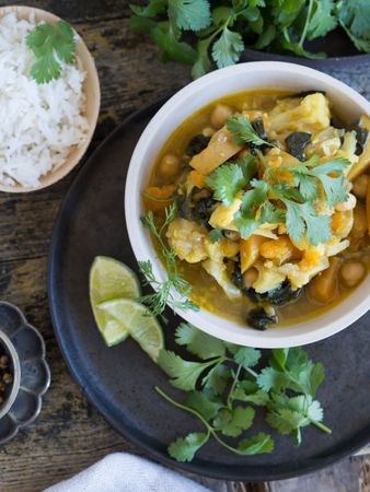 Plate with vegetarian curry on tray