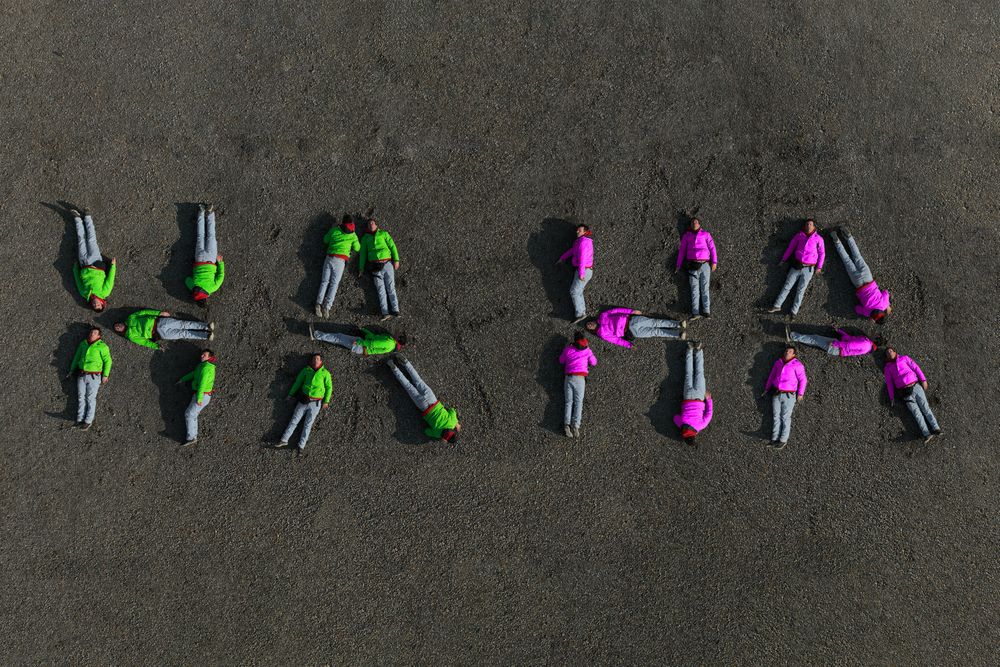 Aerial image of a man forming the text '''HA HA'''.