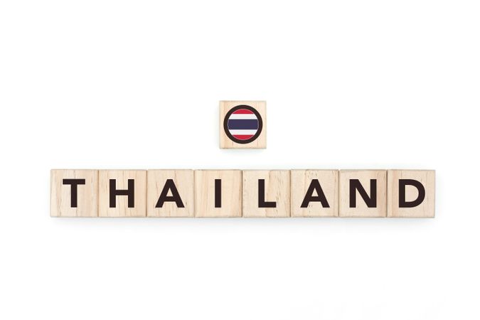 Wooden blocks bearing the name and flag of Thailand. Thai and Southeast Asian Culture, national identity, travel, and geography in a copy space design.