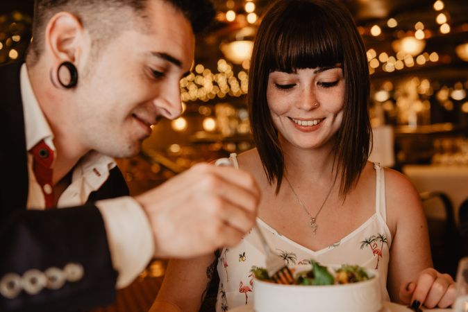 Young couple eating salad on date