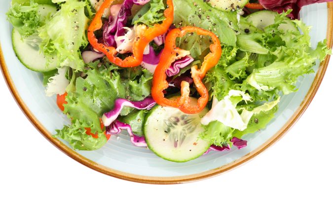 Plate with fresh salad isolated on blank background