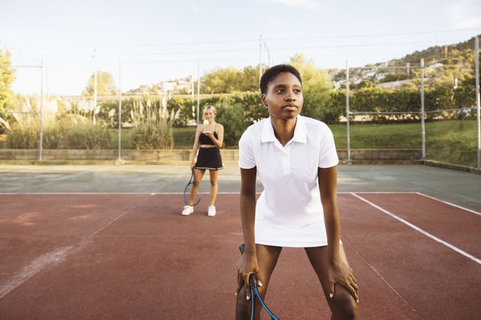 Two young women playing tennis