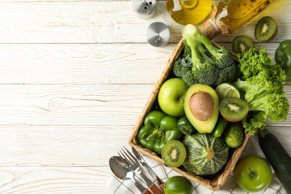 Concept of healthy food with vegetables and fruits on wooden table