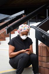 Woman nurse takes a break from shift looking at smart  phone