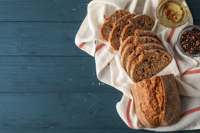 Composition with freshly baked bread on wooden background, top view and space for text