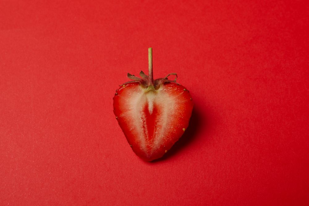 Tasty strawberry on red background. Summer berry