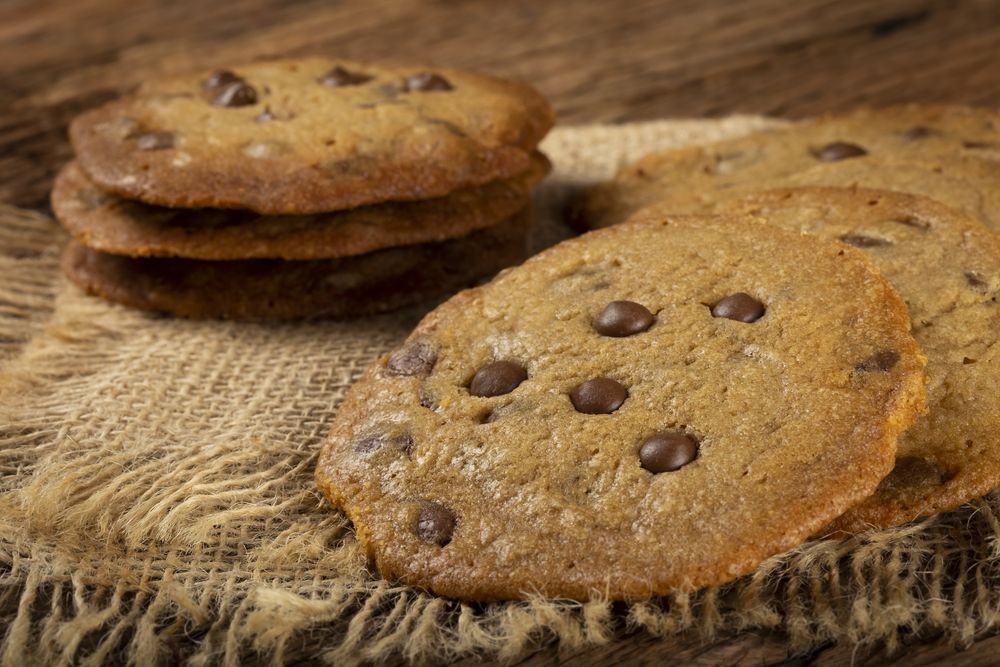 Delicious chocolate cookies on wooden table.