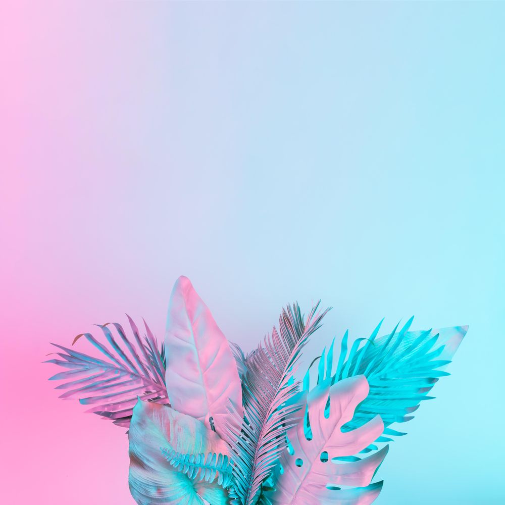 Tropical and palm leaves in vibrant bold gradient holographic colors