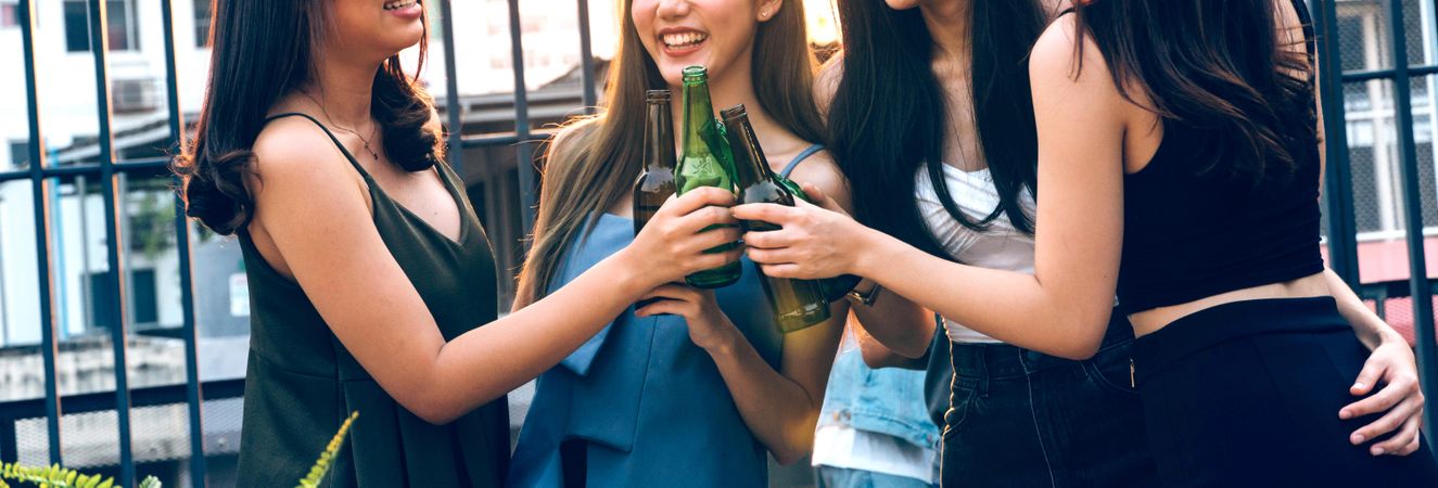 Banner of Asian female friends toasting their beer together