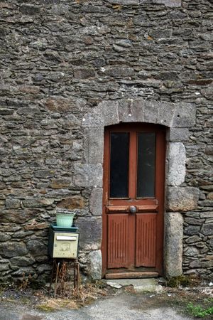 Rustic rocky wall with door