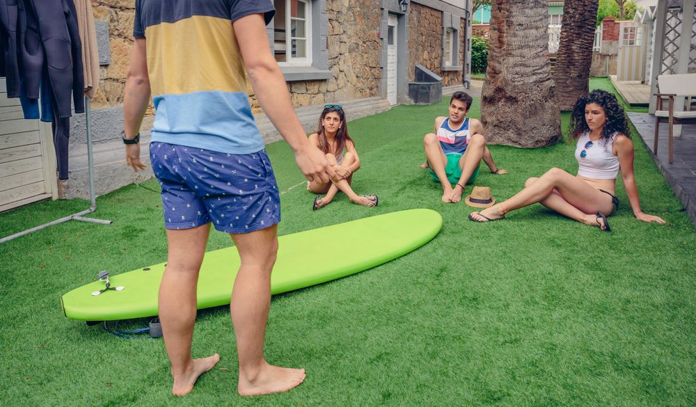 Group of people attending a summer surf class