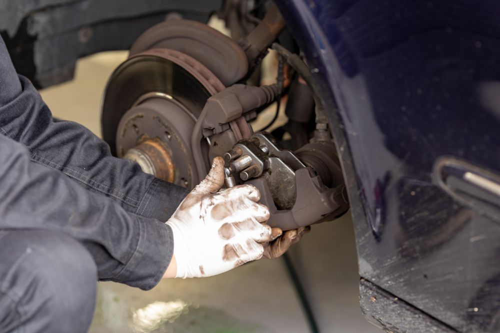 Cropped image of mechanic changing wheel