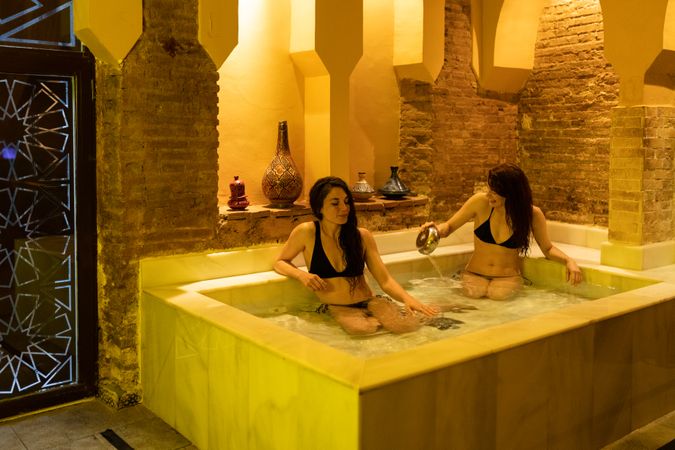 Women sitting in marble bath in Arabic spa
