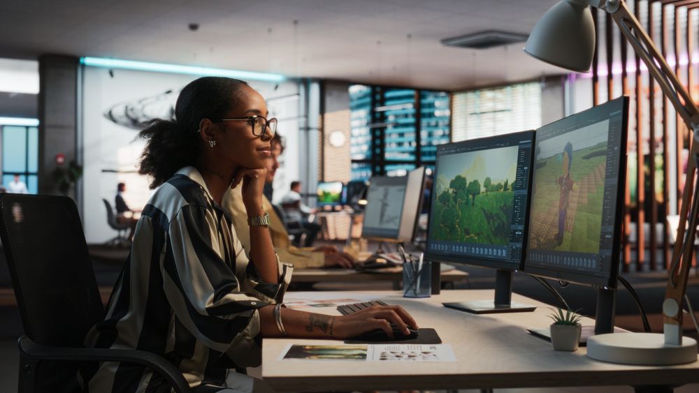 Female Black Game Developer Using Desktop Computer, Designing Unique World And Characters In 3D modelling Software For Adventure Video Game.