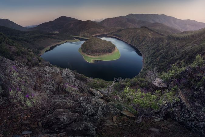 Small island on lake in mountain landscape