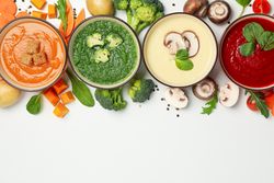 Colorful autumn soups arranged on top of picture with copy space
