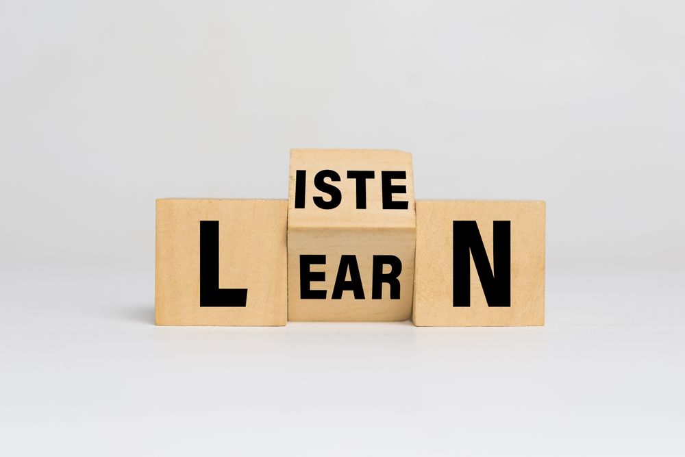 listen and learn words on turn wooden blocks isolated on light background