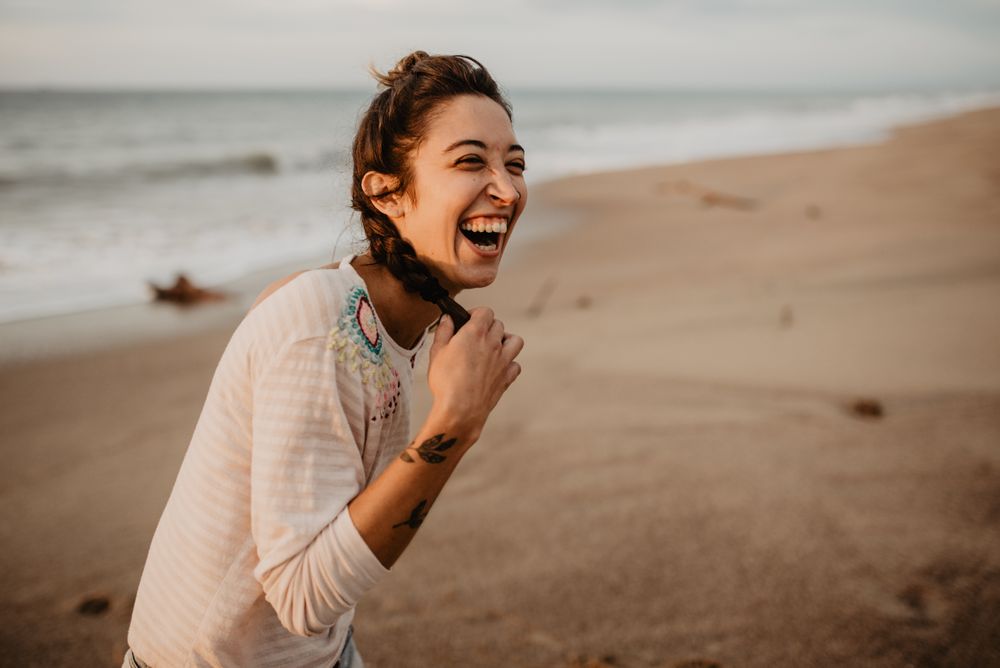 Young woman laughing on beach
