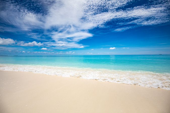 Crystal clear water under a blue sky with clouds