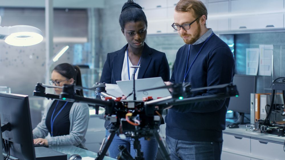 Male and Female Engineers  Work in a Bright Modern High-Tech Laboratory.