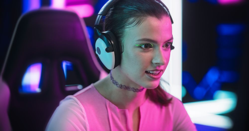 Stylish Streamer or Gamer Playing Games with Internet Players in a Futuristic Neon Studio Room
