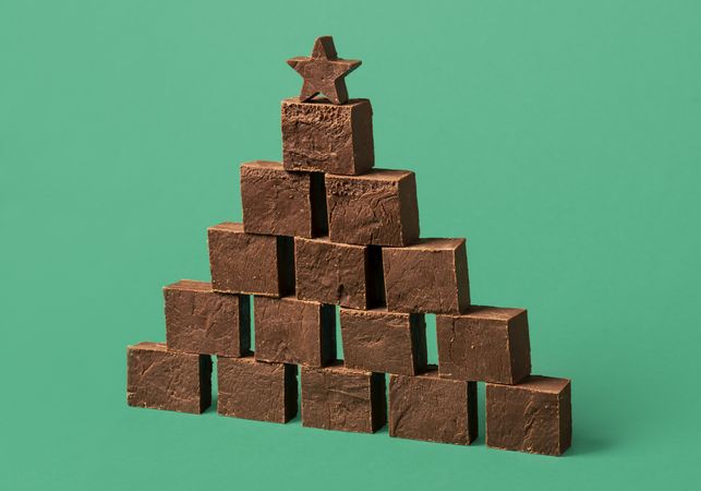 Chocolate fudge pile, on a green background
