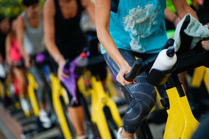 Group of people on stationary bikes at spinning class