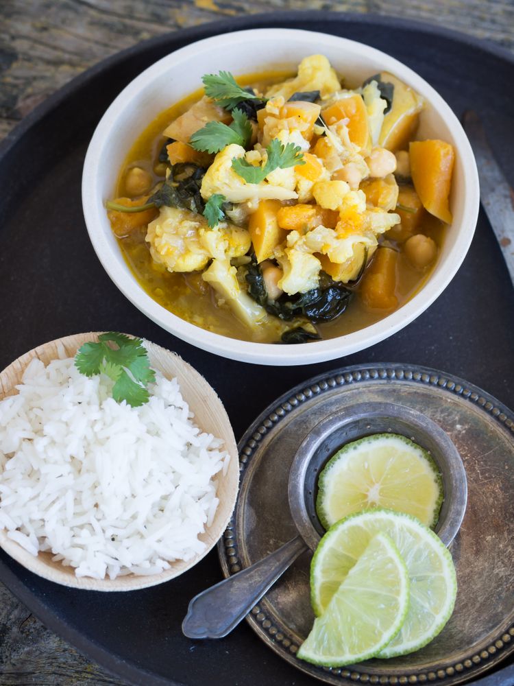 Plate with vegetarian curry on tray