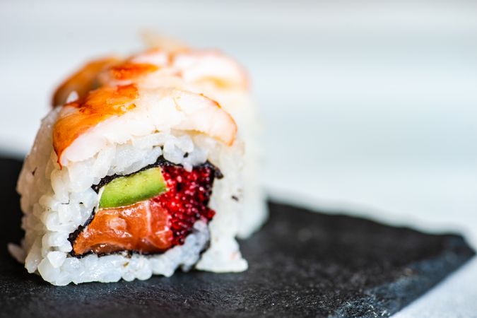 Sushi rolls with prawn, avocado and salmon with copy space