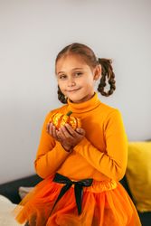 Little Girl Playing With a Pumpkin.