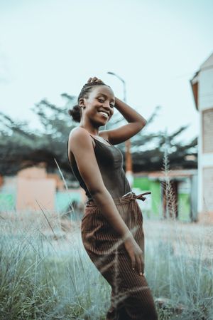 Woman posing on green grass field