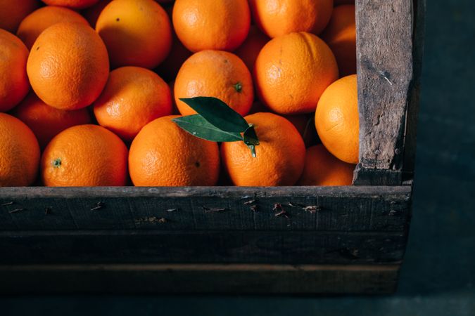Fresh oranges in an old wooden box