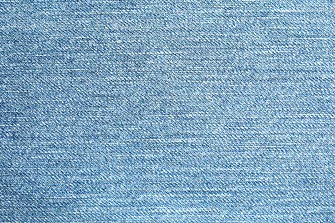Texture of blue jeans as background, space for text