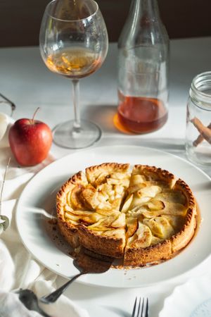 Baked apple tart on table with pie knife