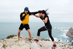Kickboxers training on cliff
