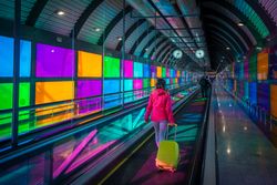 Woman standing on travelator in airport