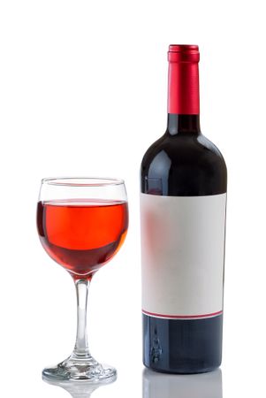 Red Wine in Glass next to full bottle on plain background
