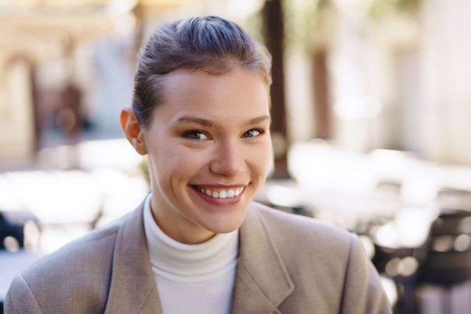 A Smiling Businesswoman Posing in an Outdoor Setting, Full of Modern Elegance and Style