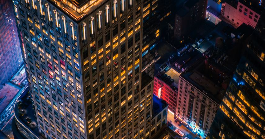High Angle Aerial Helicopter Photo Over Midtown Manhattan Skyscrapers Cityscape with Lights from Windows, Illumination, Advertising Billboards. Beautiful Night in New York City