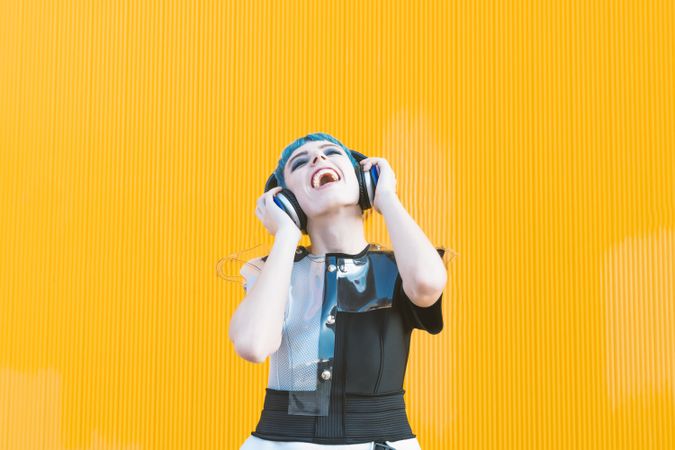 Cool informal woman in headphones on street