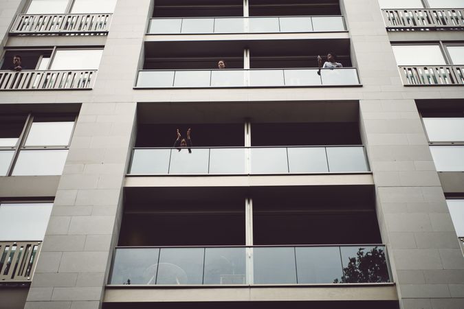 London, England, United Kingdom - June 6th, 2020: People looking out of apartment balconies