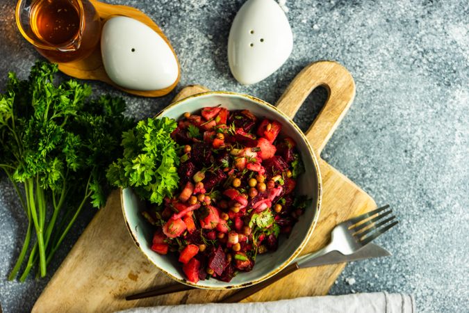 Top view of colorful beetroot salad on grey counter with copy space