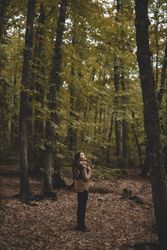 Young female resting in autumn forest