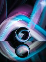 Crystal ball on board near abstract shines